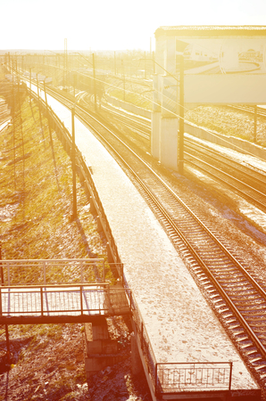 Empty railway station platform for waiting trains "Novoselovka" in Kharkiv, Ukraine. Railway platform in sunny winter dayのeditorial素材