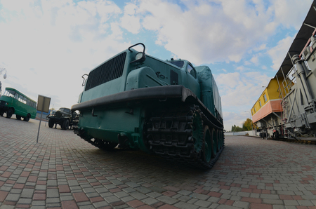 Photo of a Russian green armored car on a caterpillar track among the railway trains. Strong distortion from the fisheye lensのeditorial素材