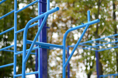Sports bars in blue on the background of a street sports ground for training in athletics. Outdoor...