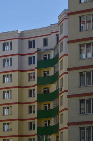New or recently completed multi-storey residential building with windows and balconies. Russian type of house buildingのeditorial素材
