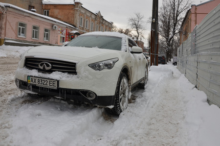 KHARKOV, UKRAINE - DECEMBER 4, 2016: A parked car under a thick layer of snow. Consequences of a strong and unexpected snowfall in Ukraineのeditorial素材