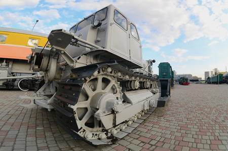 Photo of a gray bulldozer among the railway trains. Strong distortion from the fisheye lensのeditorial素材