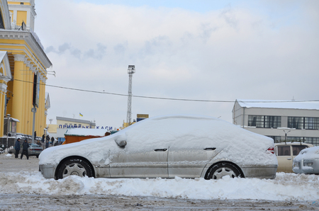 KHARKOV, UKRAINE - DECEMBER 4, 2016: A parked car under a thick layer of snow. Consequences of a strong and unexpected snowfall in Ukraineのeditorial素材