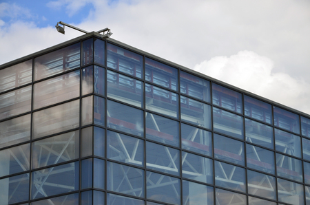 The corner of the glazed office building with the built-in modern street lampのeditorial素材