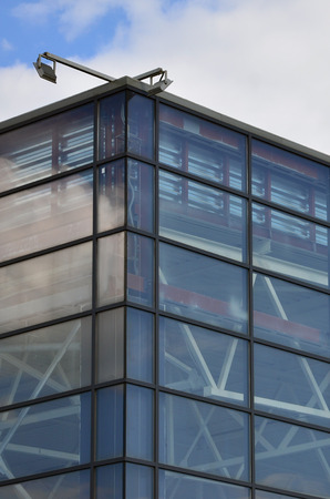 The corner of the glazed office building with the built-in modern street lampのeditorial素材
