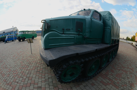 Photo of a Russian green armored car on a caterpillar track among the railway trains. Strong distortion from the fisheye lensのeditorial素材