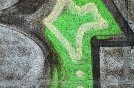Concrete weathered worn wall damaged paint. Grungy Concrete Surface with graffiti colors and outlines. Street art background texture. Close up painted wall of the cityのeditorial素材
