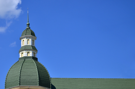 Completed perfect high-quality roofing work from metal roofing. The dome of a polyhedral shape with a spire is covered with green metal tilesのeditorial素材