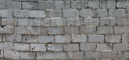 Texture of brick wall from relief stones under bright sunlightの写真素材