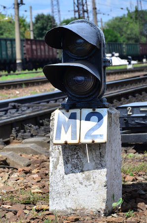 Railway traffic light (semaphore) against the background of a day railway landscape. Signal device on the railway trackのeditorial素材