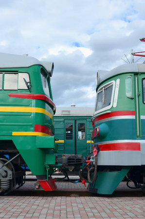 Cabs of modern Russian electric trains. Side view of the heads of railway trains with a lot of wheels and windows in the form of portholesのeditorial素材