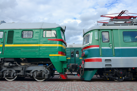 Cabs of modern Russian electric trains. Side view of the heads of railway trains with a lot of wheels and windows in the form of portholesのeditorial素材
