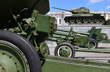 Photo of three guns of the Soviet Union of the Second World War against the background of the green tank T-34のeditorial素材