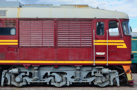 Cabin of modern Russian electric train. Side view of the head of railway train with a lot of wheels and windows in the form of portholesのeditorial素材