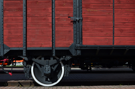The side of the old brown wooden freight car with the wheel of the times of the Soviet Unionのeditorial素材