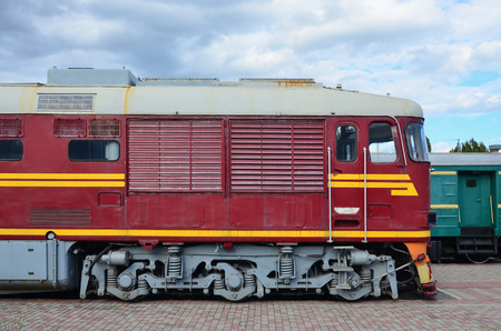 Cabin of modern Russian electric train. Side view of the head of railway train with a lot of wheels and windows in the form of portholesのeditorial素材