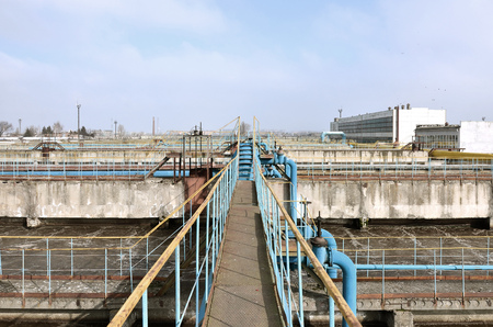 Industrial space with lots of pipes and communications on a background of blue sky. old water treatment plant on the city's water supply enterprise. Kharkov, Ukraineの写真素材