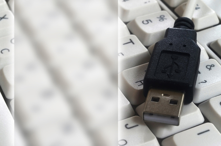 Black USB input on the white classic computer keyboard with english and russian layout with copy space fieldの写真素材