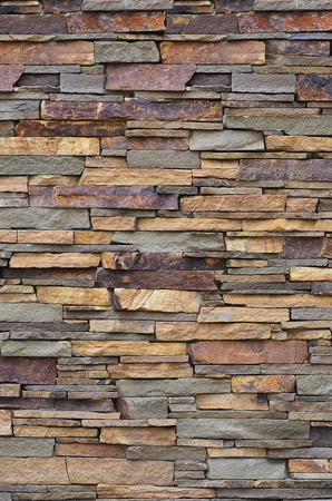 Texture of a stone wall from long and rough stones of different sizes and tonesの写真素材