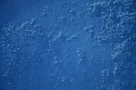 Texture of a metal wall with an old paint coating that spoils under the influence of time and weatherの写真素材
