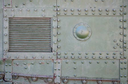 The texture of the wall of the tank, made of metal and reinforced with a multitude of bolts and rivets. Images of the covering of a combat vehicle from the Second World Warの写真素材