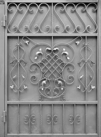The texture of the silver metal gate with a beautiful floral pattern of forged metalの写真素材