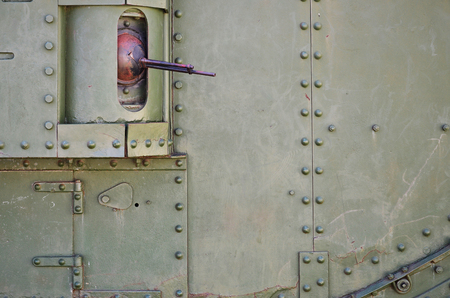 The texture of the wall of the tank, made of metal and reinforced with a multitude of bolts and rivets. Images of the covering of a combat vehicle from the Second World War with a guided machine gunの写真素材