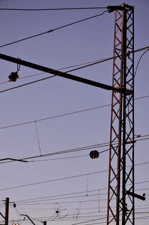 Railroad overhead lines against clear blue sky, Contact wire. High voltage railroad power lines on neutral blue sky backgroundの写真素材
