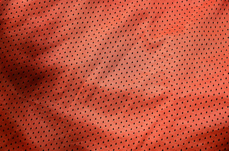 Sport clothing fabric texture background, top view of red cloth textile surfaceの写真素材