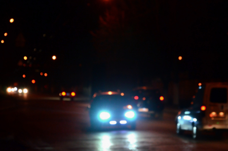 Artistic style - Defocused urban abstract texture, blurred background with bokeh of city lights from car on street at night, vintage or retro color toneの写真素材