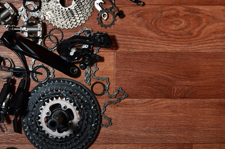 Many different metal parts and components of the running gear of a sports bike. Brake levers, sprockets, gears, pinions and many other components for bicycle assembly. Bicycle repair conceptの写真素材