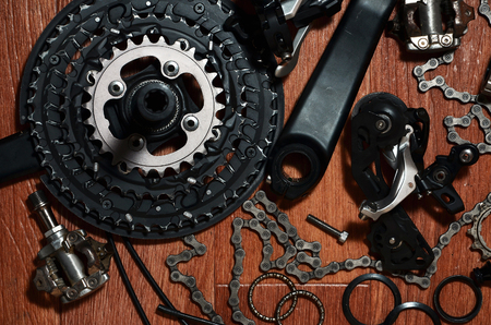Many different metal parts and components of the running gear of a sports bike. Brake levers, sprockets, gears, pinions and many other components for bicycle assembly. Bicycle repair conceptの写真素材
