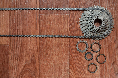Some composition of a bicycle chain, several sprockets and other components of a sports bike. Metal...