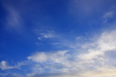 Heavenly space of blue color with a lot of thick white clouds. Background picture of a cloudy sky showing favorable weatherの写真素材