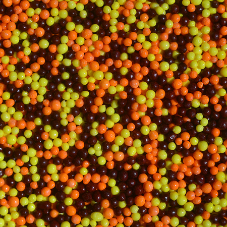 Background picture of a variety of colored glazed powder in the form of small balls. A huge number of sweet, colorful beads of very small size for decoration of pastry products
の写真素材