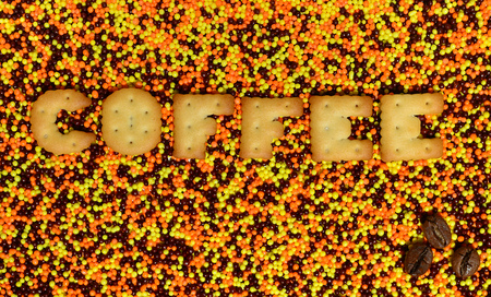 Coffee. The word from the edible cracker letters lies on the glazed powder. A huge number of sweet, colorful 
beads of very small size for decoration of pastry products の写真素材