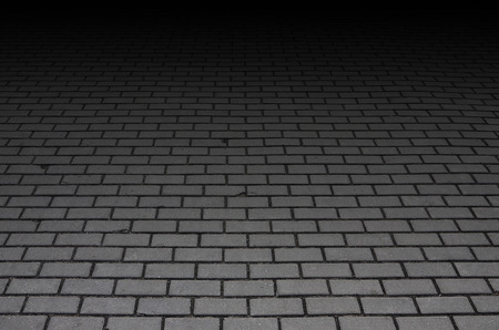 Photo of the site from the old paving slab with small defects and cracks, leaving in perspective. Street coverage of pedestrian areas and paths in parks in daylight outdoorsの写真素材
