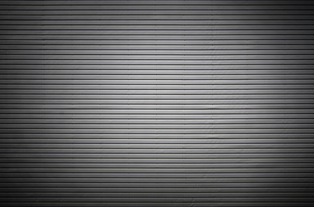 The texture of a metal wall or a surface of corrugated metal with invisible light sources that illuminate the middle of the platform for product placementの写真素材