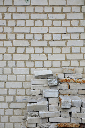 A photo of a set of old bricks that are stacked in a multilayered pile of neat rows. Construction raw materials ready to start workの写真素材