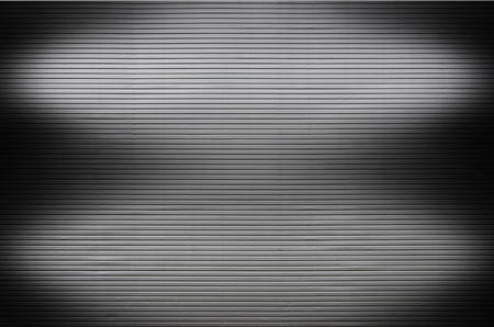 The texture of a metal wall or a surface of corrugated metal with invisible light sources that illuminate the middle of the platform for product placementの写真素材