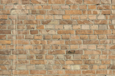 The texture of red wall from a variety of old and dirty brick. Detailed pattern of a plurality of different sizes of brick worn outの写真素材