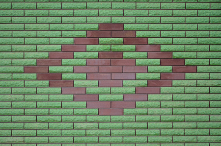 The texture of the walls of the modern high-quality stone brick. Smooth texture of pink brick wall in bright sunlight in the daytime outdoorsの写真素材
