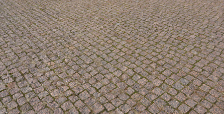 Cobbles texture - hard pavement, a kind of pavement, laid out by flat rectangular (or other shape) bars of approximately the same shape and sizeの写真素材