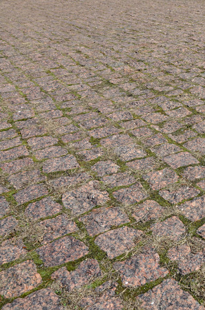 A large area, laid out of paving stone in perspective. Detailed photo of paving stones in the sidewalk avenue close-upの写真素材