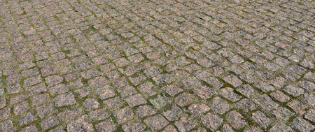 A large area, laid out of paving stone in perspective. Detailed photo of paving stones in the sidewalk avenue close-upの写真素材