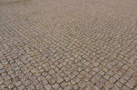 A large area, laid out of paving stone in perspective. Detailed photo of paving stones in the sidewalk avenue close-upの写真素材