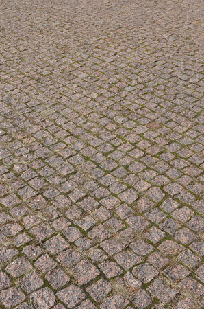 A large area, laid out of paving stone in perspective. Detailed photo of paving stones in the sidewalk avenue close-upの写真素材