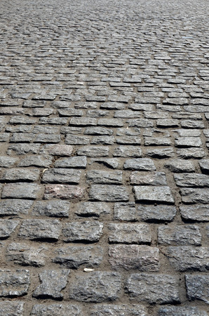 A large area, laid out of paving stone in perspective. Detailed photo of paving stones in the sidewalk avenue close-upの写真素材