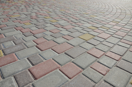 A large area, laid out of paving stone in perspective. Detailed photo of paving stones in the sidewalk avenue close-upの写真素材