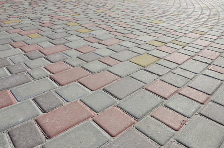 A large area, laid out of paving stone in perspective. Detailed photo of paving stones in the sidewalk avenue close-upの写真素材